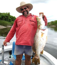 Hire a boat or bring your own and catch a barramundi at Daly River